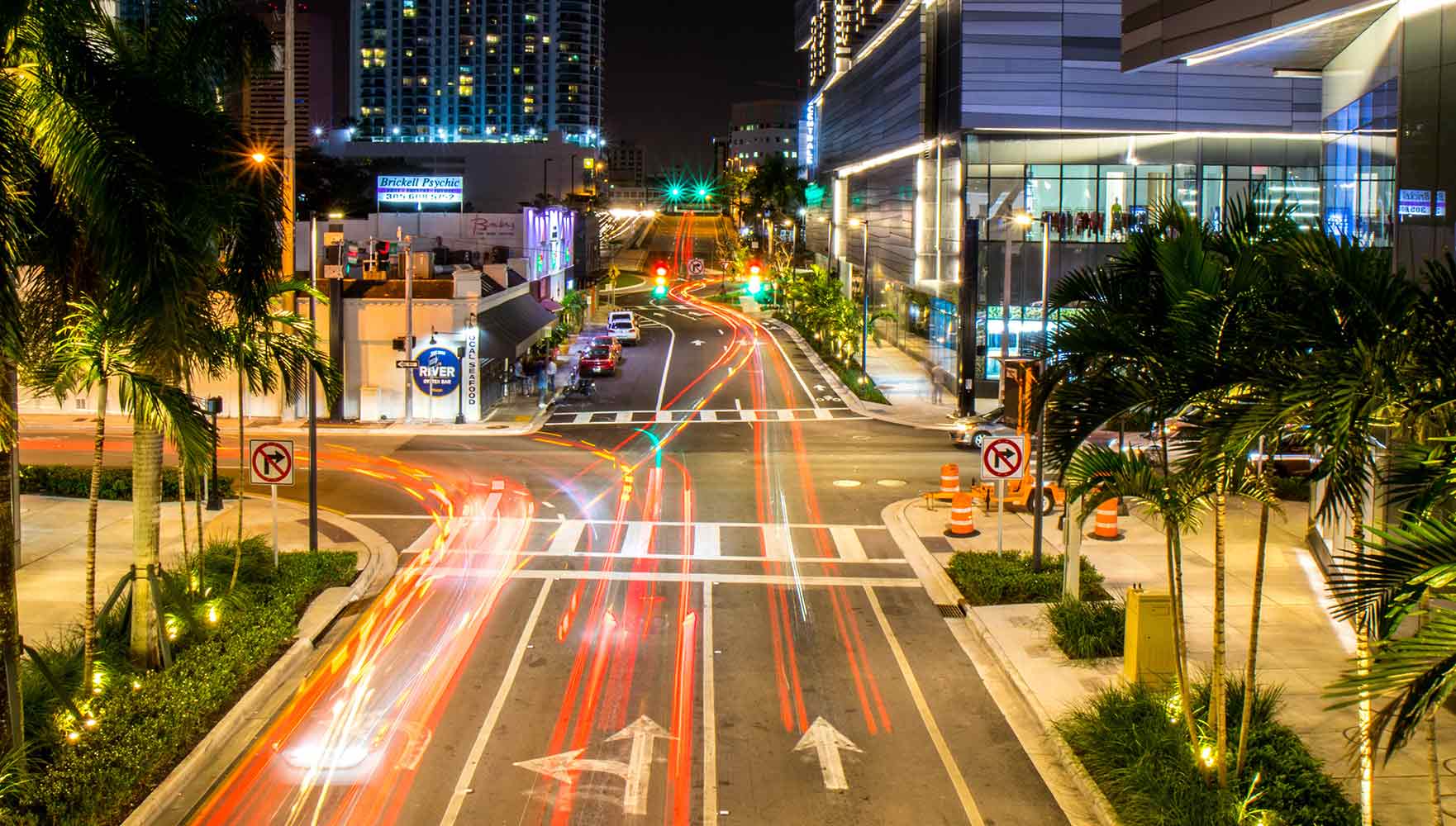 Seeing traffic through an intersection with blurry car lights representing movement